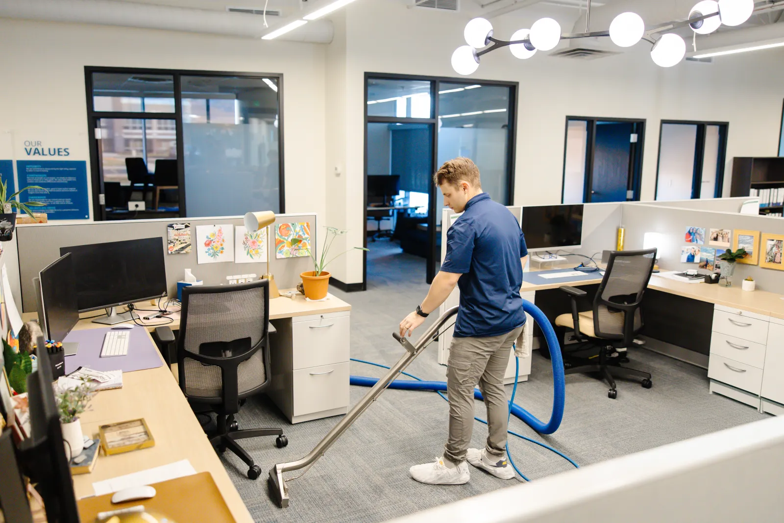 technician cleaning an office with a wand